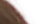 A 40 by 24 pixel corner of the Braids on pink cutout at ten times its size: brown strands of hair fading into the transparency checker